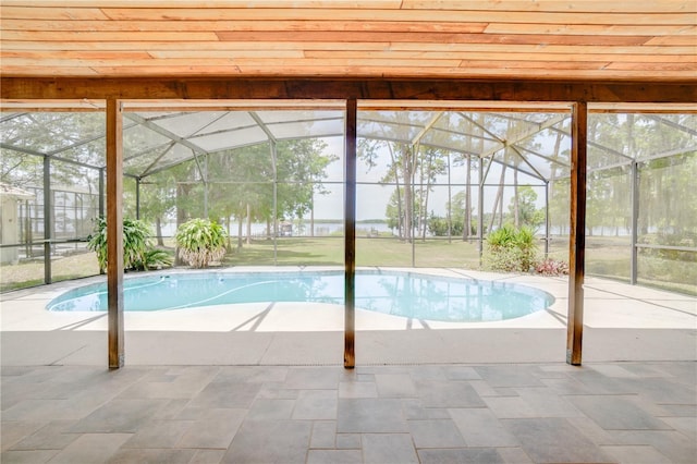 outdoor pool with a lanai and a patio area