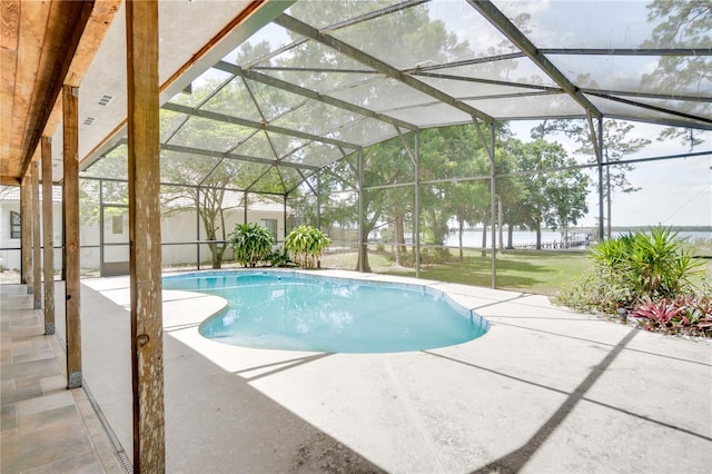 outdoor pool featuring a patio, a lawn, and a lanai