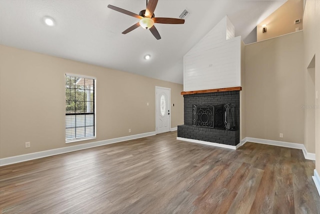 6803 Round Lake Rd, Mount Dora, FL 32757 - unfurnished living room with ceiling fan, a fireplace, wood finished floors, baseboards, and high vaulted ceiling