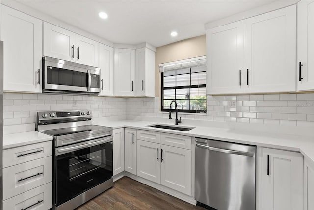 6803 Round Lake Rd, Mount Dora, FL 32757 - kitchen with appliances with stainless steel finishes, a sink, light countertops, dark wood-style floors, and recessed lighting