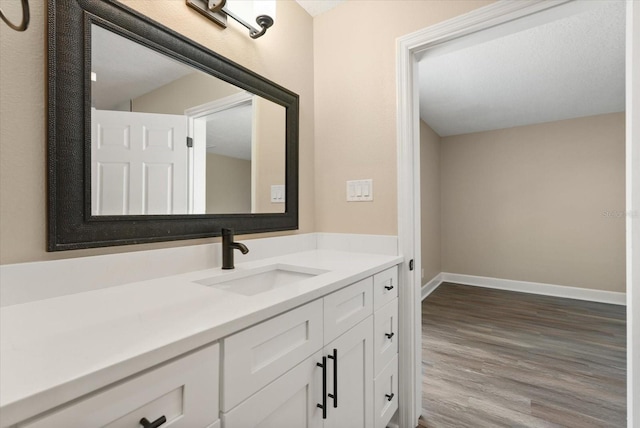 6803 Round Lake Rd, Mount Dora, FL 32757 - bathroom featuring wood finished floors, baseboards, and vanity