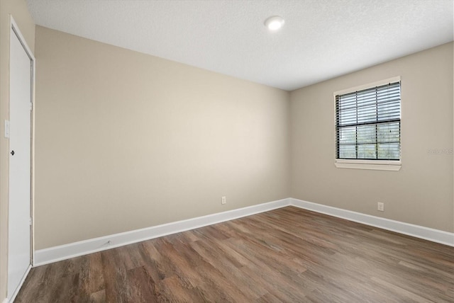 6803 Round Lake Rd, Mount Dora, FL 32757 - spare room with wood finished floors, baseboards, and a textured ceiling