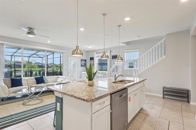 7554 Oak Spring Ln, Davenport, FL 33837 - kitchen featuring dishwasher, a sink, open floor plan, white cabinetry, and light stone countertops