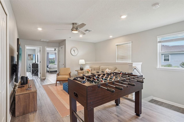 7554 Oak Spring Ln, Davenport, FL 33837 - recreation room featuring a ceiling fan, wood finished floors, baseboards, recessed lighting, and a textured ceiling