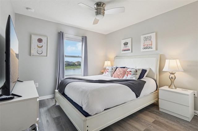 7554 Oak Spring Ln, Davenport, FL 33837 - bedroom with wood finished floors, baseboards, and ceiling fan