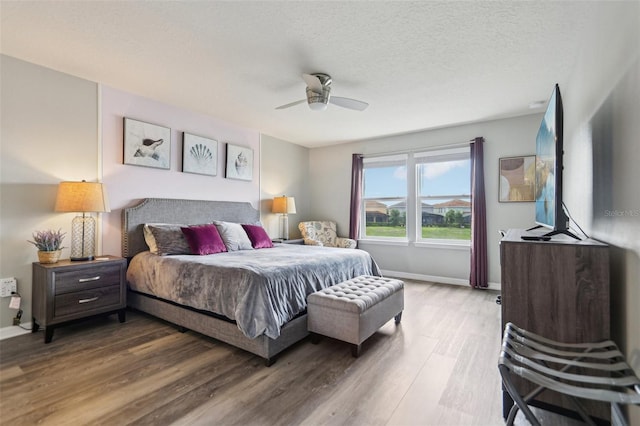 7554 Oak Spring Ln, Davenport, FL 33837 - bedroom featuring wood finished floors, baseboards, and ceiling fan