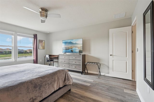 7554 Oak Spring Ln, Davenport, FL 33837 - bedroom featuring wood finished floors, baseboards, and a ceiling fan