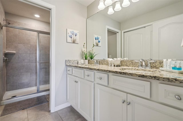 7554 Oak Spring Ln, Davenport, FL 33837 - bathroom featuring double vanity, a shower stall, tile patterned floors, baseboards, and a chandelier