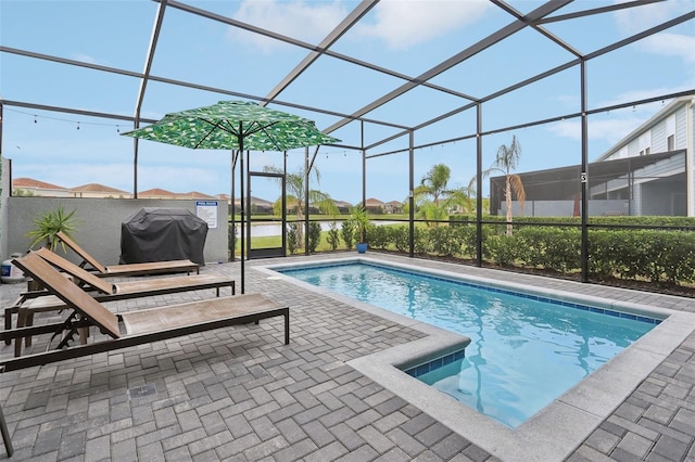 7554 Oak Spring Ln, Davenport, FL 33837 - outdoor pool with area for grilling, a patio, and glass enclosure