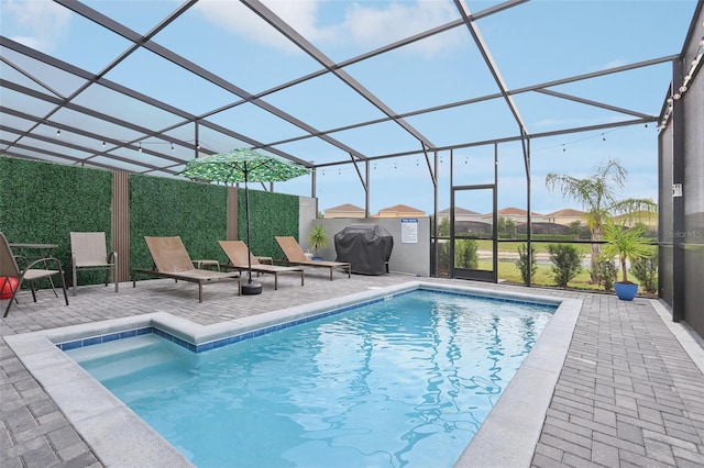 7554 Oak Spring Ln, Davenport, FL 33837 - view of pool with a patio area, grilling area, and glass enclosure