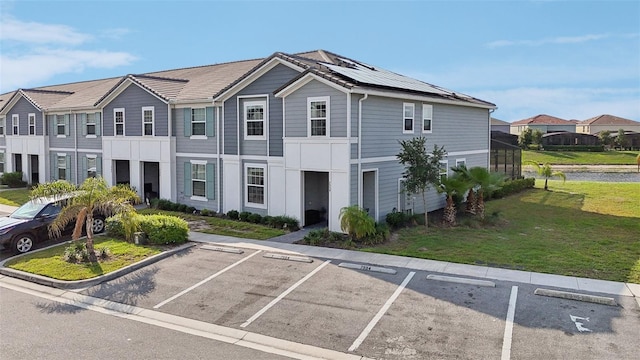 7554 Oak Spring Ln, Davenport, FL 33837 - view of property featuring uncovered parking, a front lawn, solar panels, and a residential view