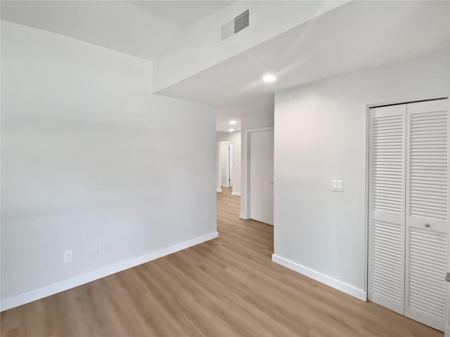 spare room with visible vents, recessed lighting, baseboards, and light wood-style floors