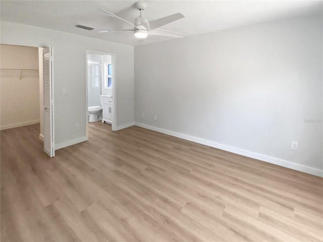 unfurnished bedroom featuring baseboards, a spacious closet, visible vents, and a closet