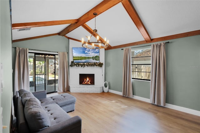 living room with baseboards, a chandelier, vaulted ceiling with beams, and visible vents