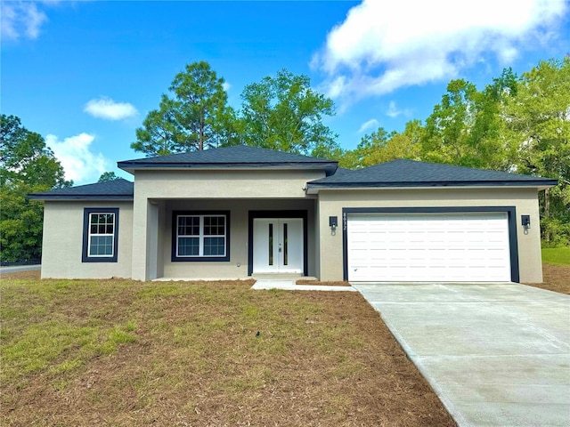 view of front of home featuring a front lawn, a garage, stucco siding, french doors, and driveway