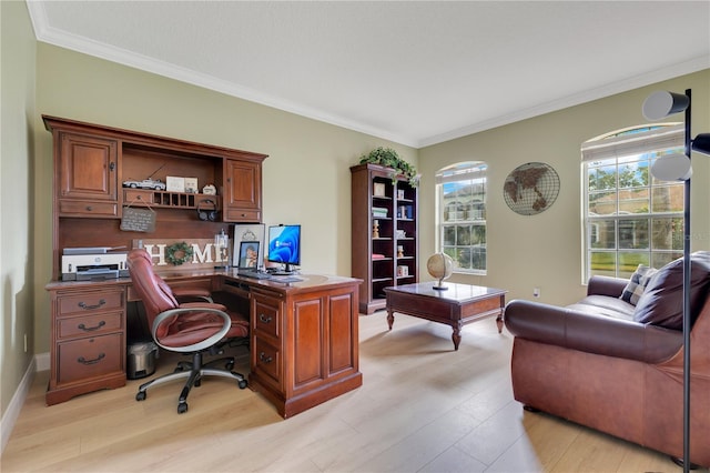 home office with light wood-type flooring and ornamental molding