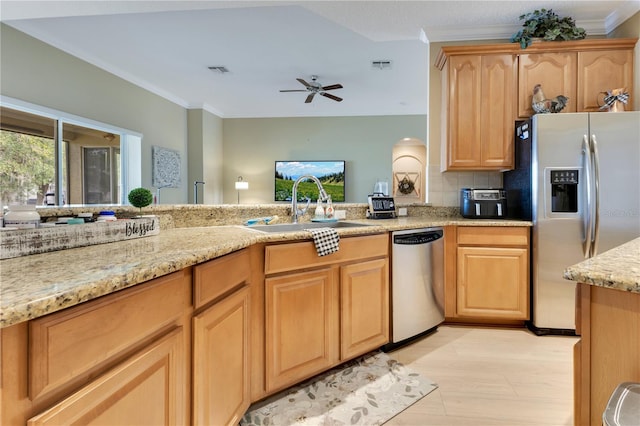 kitchen with light stone countertops, appliances with stainless steel finishes, a sink, a ceiling fan, and visible vents
