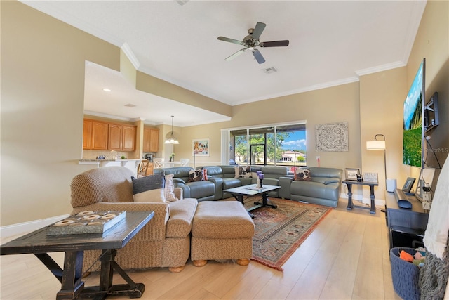 living room featuring crown molding, ceiling fan, and light wood-style floors