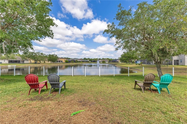 view of yard with a water view and fence