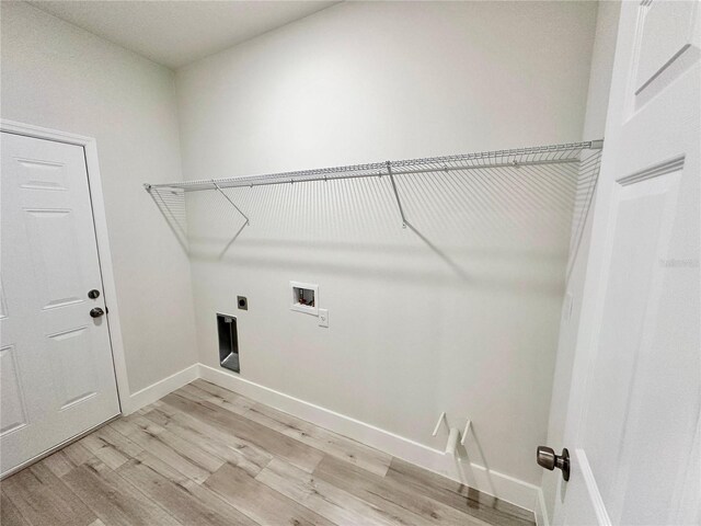 laundry room featuring hookup for an electric dryer, laundry area, baseboards, light wood finished floors, and hookup for a washing machine