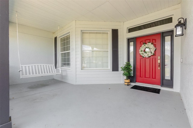 property entrance featuring a porch