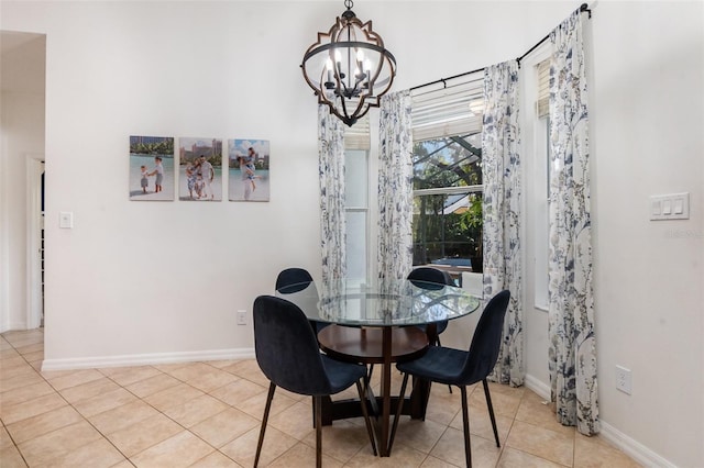 dining space with baseboards, light tile patterned flooring, and a chandelier