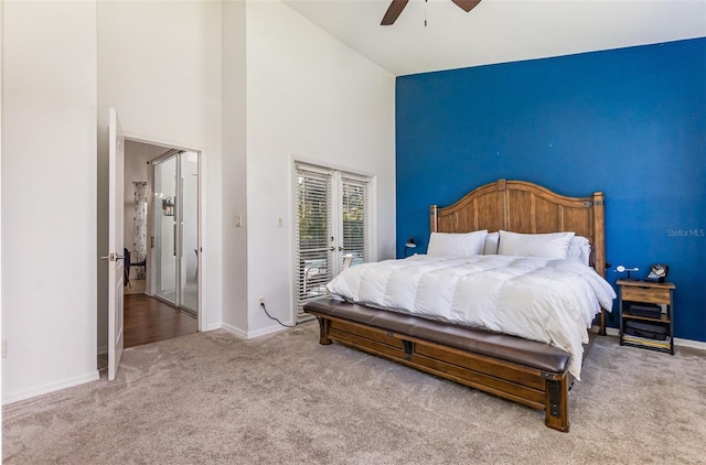 carpeted bedroom with baseboards, access to outside, a ceiling fan, and high vaulted ceiling