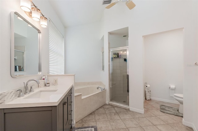 bathroom featuring tile patterned flooring, vanity, a garden tub, toilet, and a shower stall