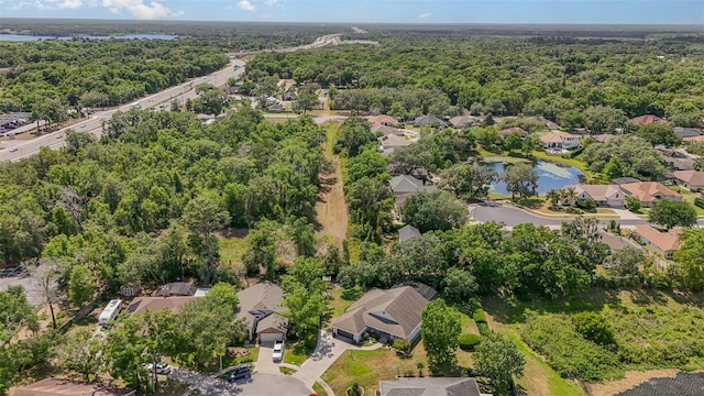 aerial view with a residential view, a view of trees, and a water view