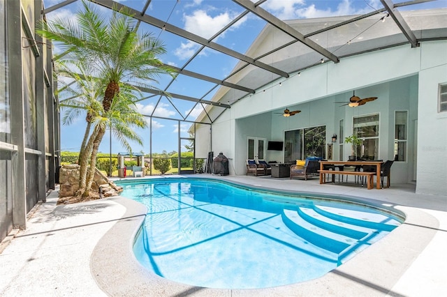 outdoor pool with a lanai, a patio, ceiling fan, and french doors