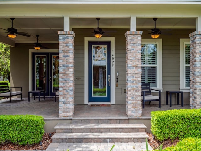 entrance to property featuring ceiling fan and a porch