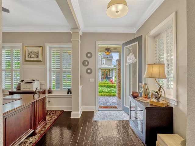 foyer entrance with ornamental molding, dark wood-style flooring, decorative columns, baseboards, and a ceiling fan