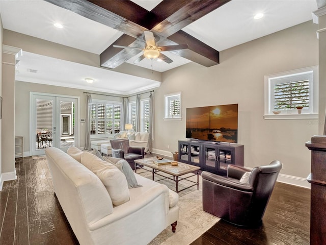 living room with baseboards, dark wood-type flooring, and ceiling fan