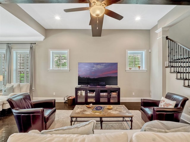 living area featuring baseboards, stairs, wood finished floors, and a wealth of natural light