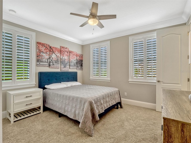 bedroom with a ceiling fan, baseboards, light colored carpet, and ornamental molding