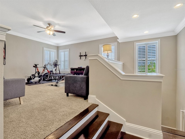 interior space featuring ceiling fan, ornamental molding, and a wealth of natural light