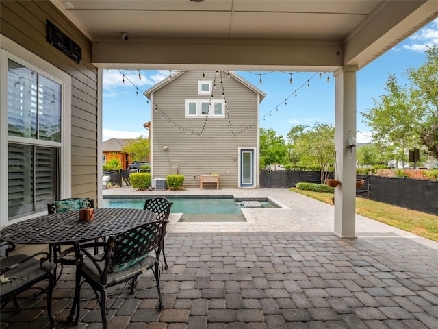 view of patio / terrace with a fenced in pool, a hot tub, and fence