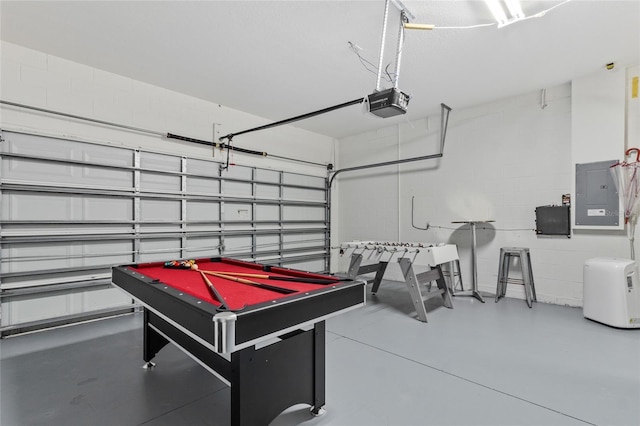 rec room featuring electric panel, billiards, concrete block wall, and a garage