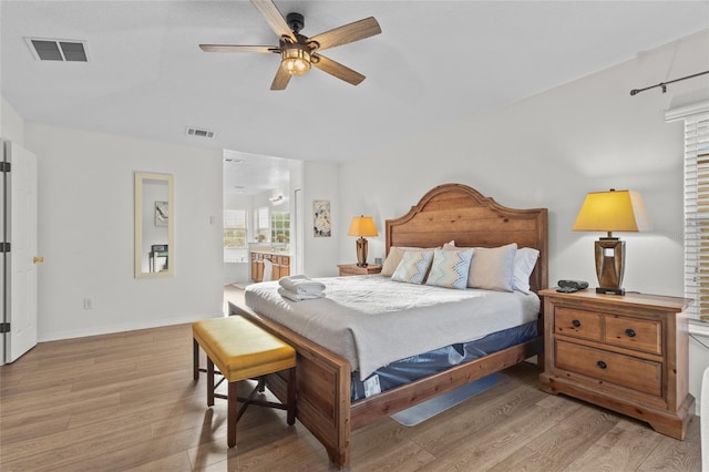 bedroom with baseboards, ceiling fan, light wood-style flooring, and visible vents