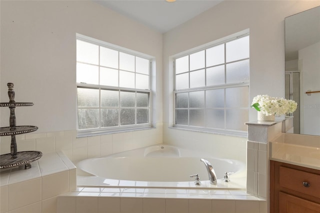 full bath with a bath and vanity