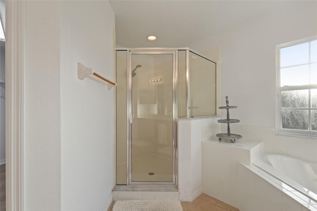 full bath featuring a garden tub, tile patterned flooring, a shower stall, and recessed lighting