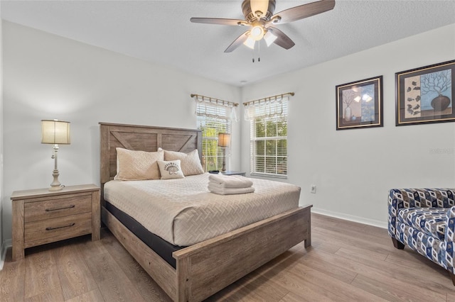 bedroom with baseboards, a ceiling fan, and wood finished floors