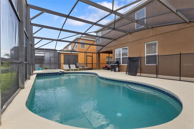 outdoor pool featuring a hot tub, a lanai, and a patio