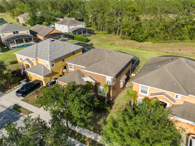 aerial view featuring a wooded view and a residential view