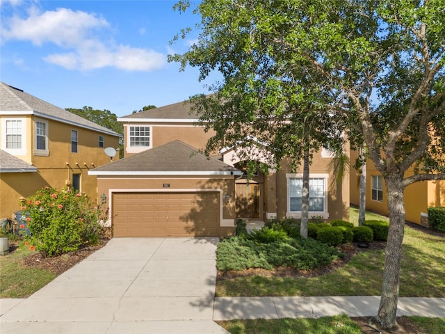 view of front facade featuring concrete driveway, stucco siding, and an attached garage
