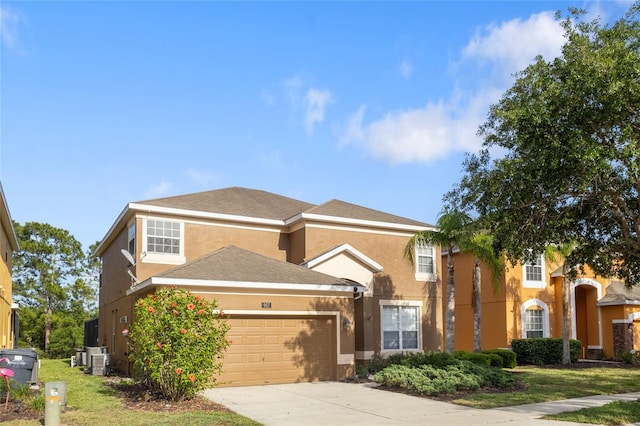view of front of home featuring concrete driveway, a garage, stucco siding, and cooling unit