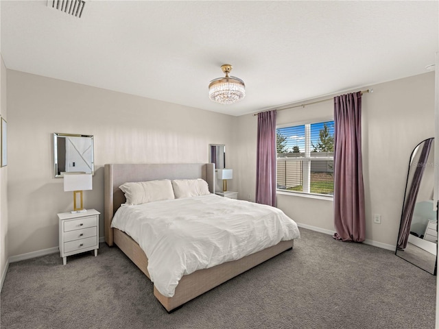 carpeted bedroom featuring baseboards and visible vents