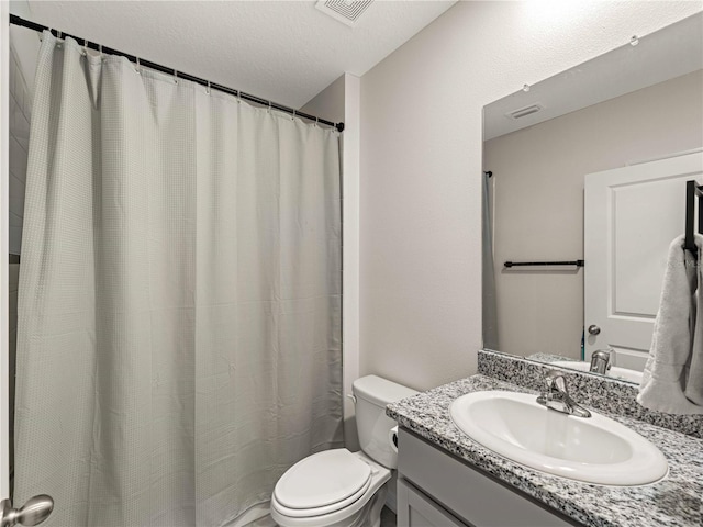 full bath featuring toilet, a textured ceiling, visible vents, and vanity