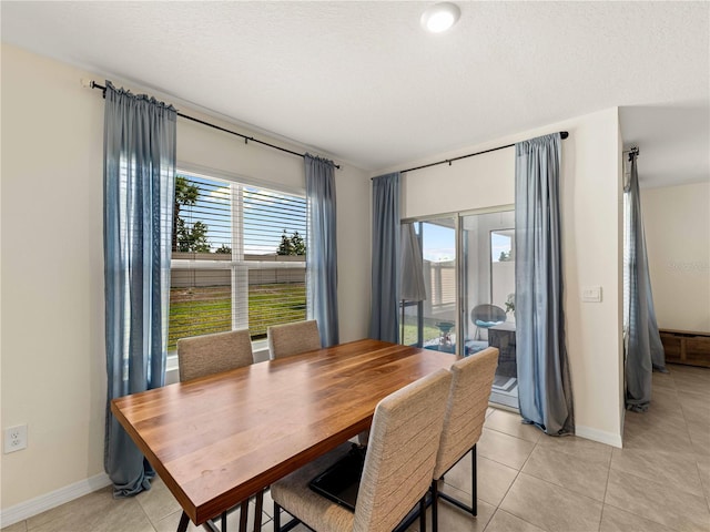dining room with light tile patterned flooring and baseboards