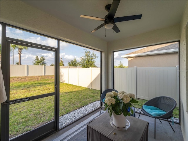 sunroom with plenty of natural light and a ceiling fan